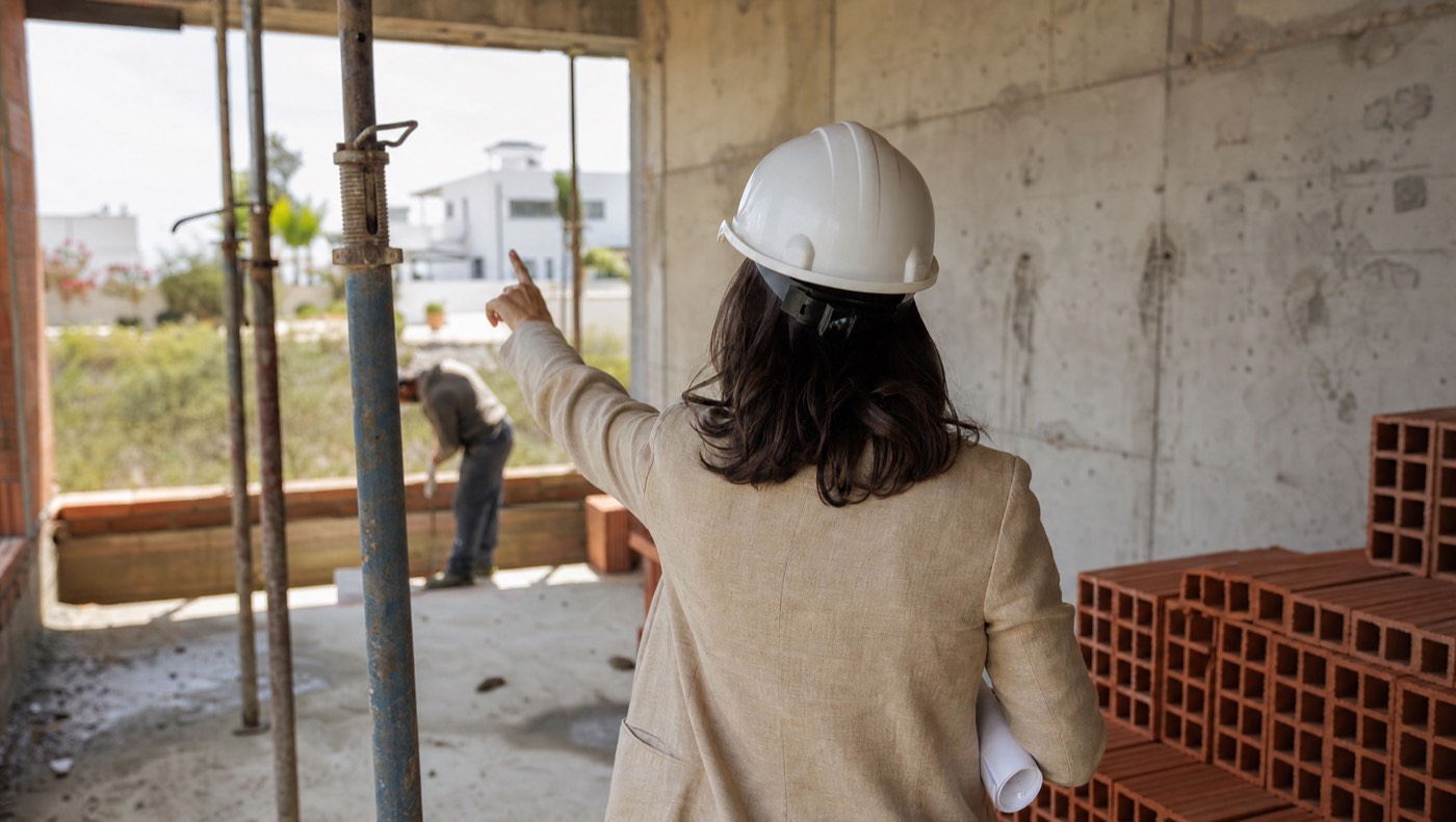 Checking a raw concrete wall on a villa construction site